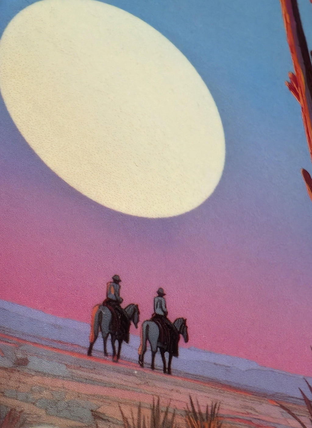 Close-up of a western-themed phone case. The macro shot shows two cowboys on horseback in a desert landscape against a giant moon in a pastel sky. The fine surface texture and vibrant, scratch-resistant colors of the sublimation print are clearly visible.