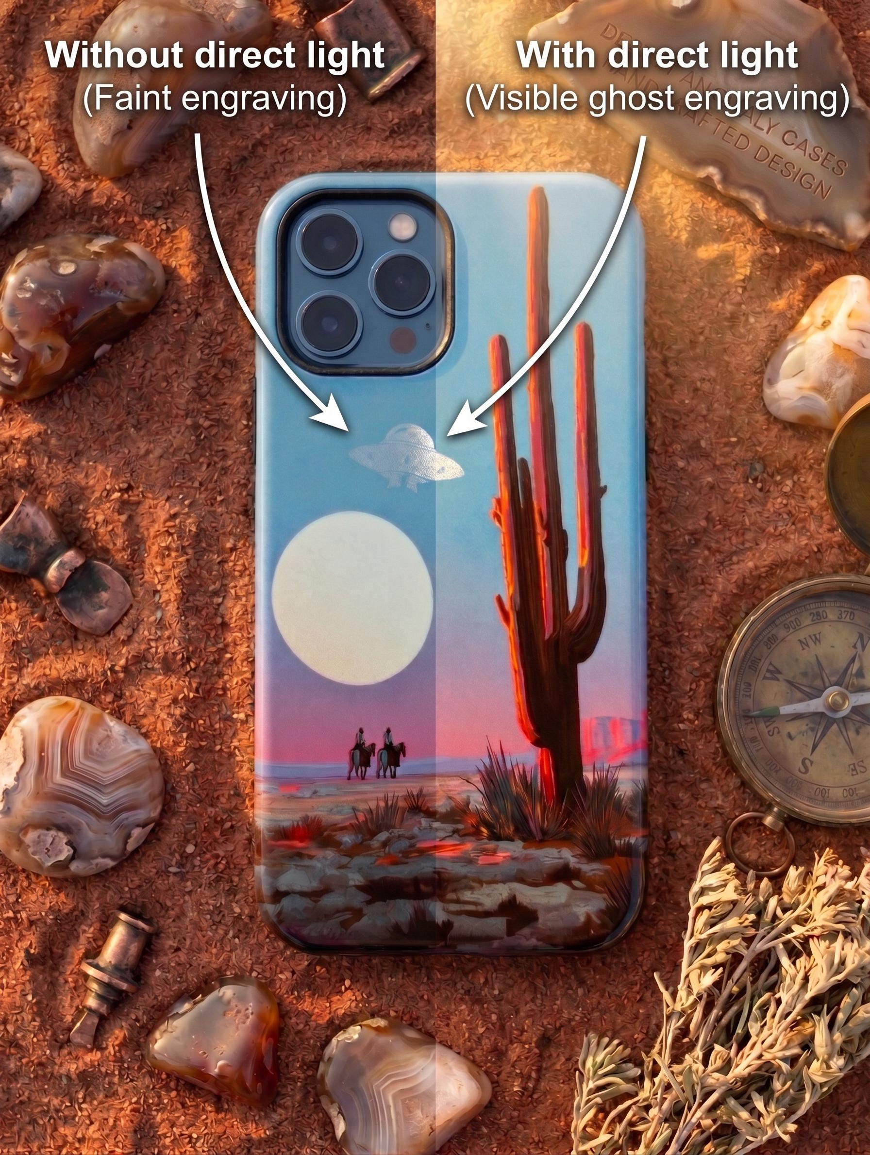 Phone case for iPhone 12 featuring a sci-fi western design. Vibrant sublimation print with a saguaro cactus, cowboys, and a UFO, enhanced with precise laser engraving. Photographed on red desert sand.
